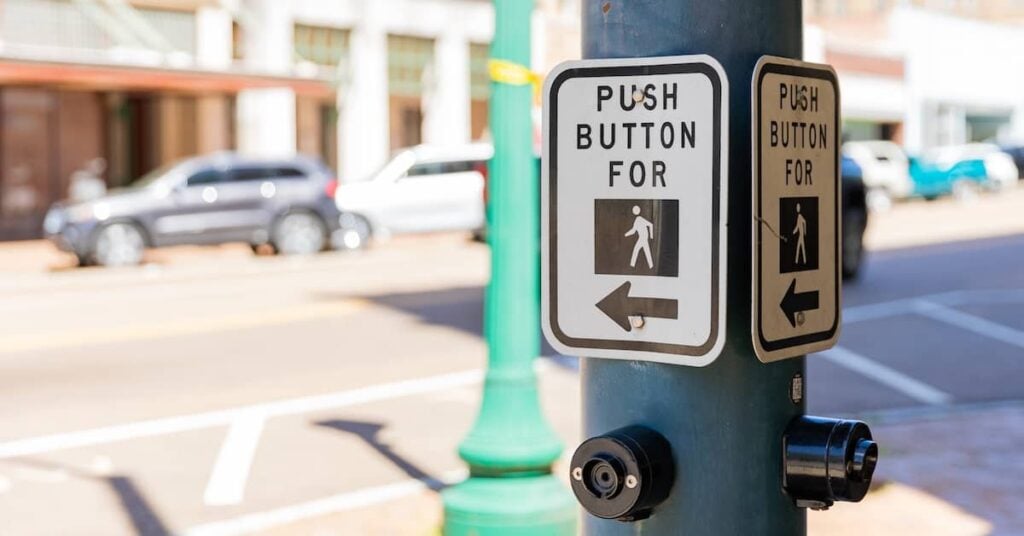 "Push button for" crossing signal at an intersection | Burg Simpson