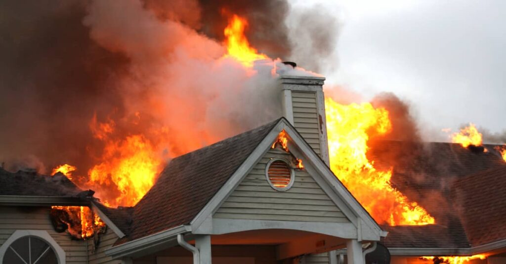 a burning house emits smoke and flames | Burg Simpson