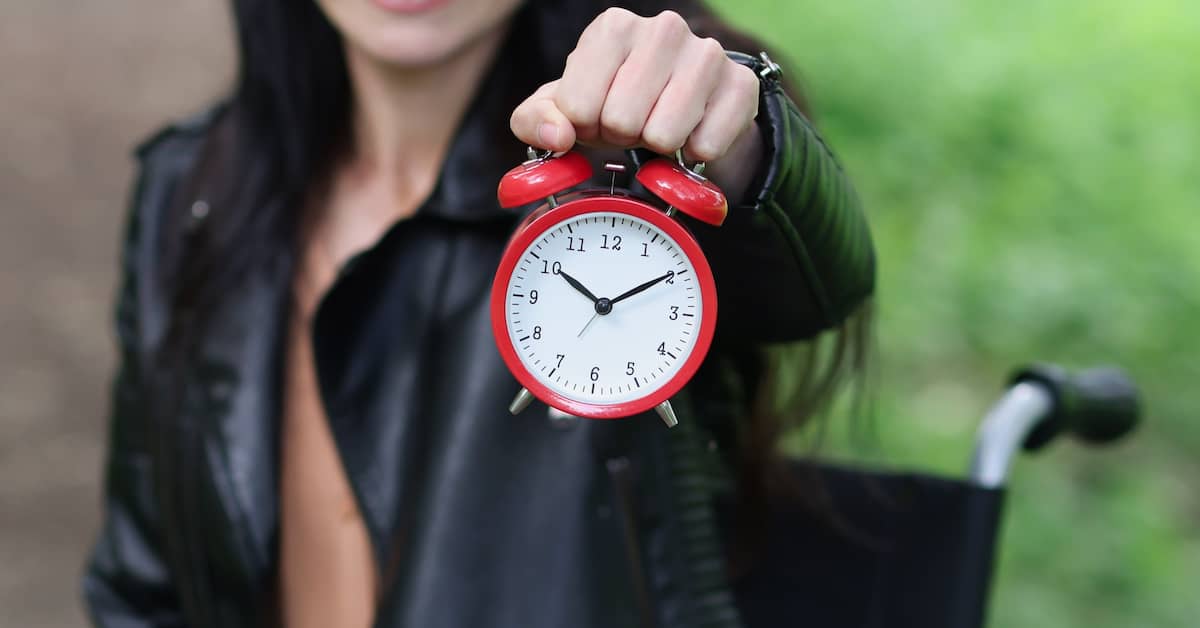 Woman holding up a clock to reflect the urgency of a personal injury claim | Burg Simpson