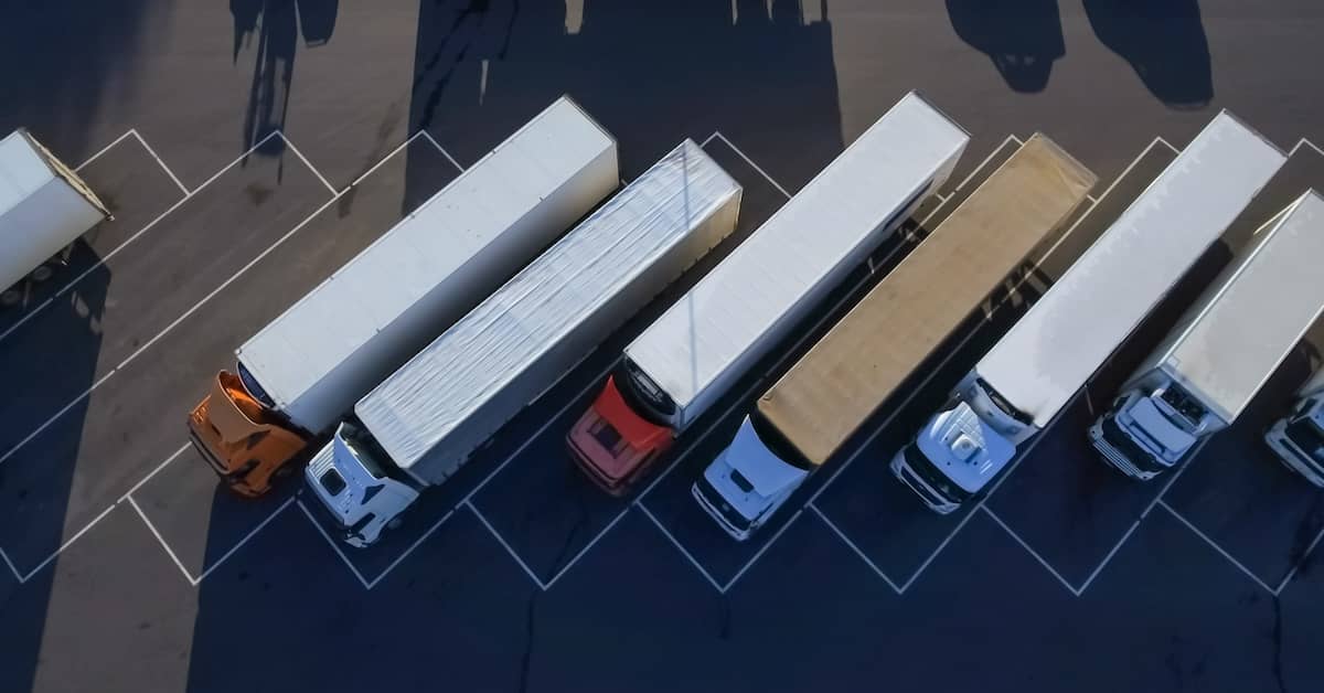 Aerial view of commercial semi-trucks in a parking lot | Burg Simpson