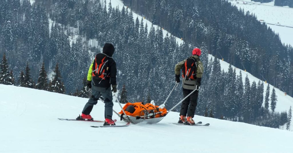 Ski patrol transporting injured skier | Burg Simpson