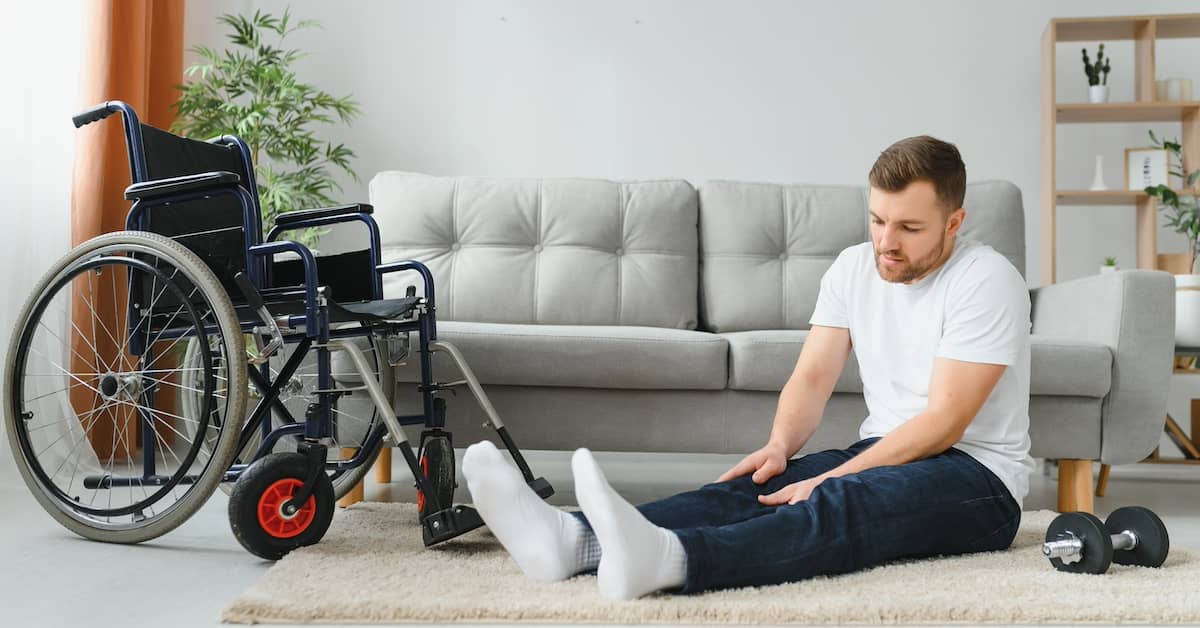 Disabled man doing physical therapy exercises | Burg Simpson