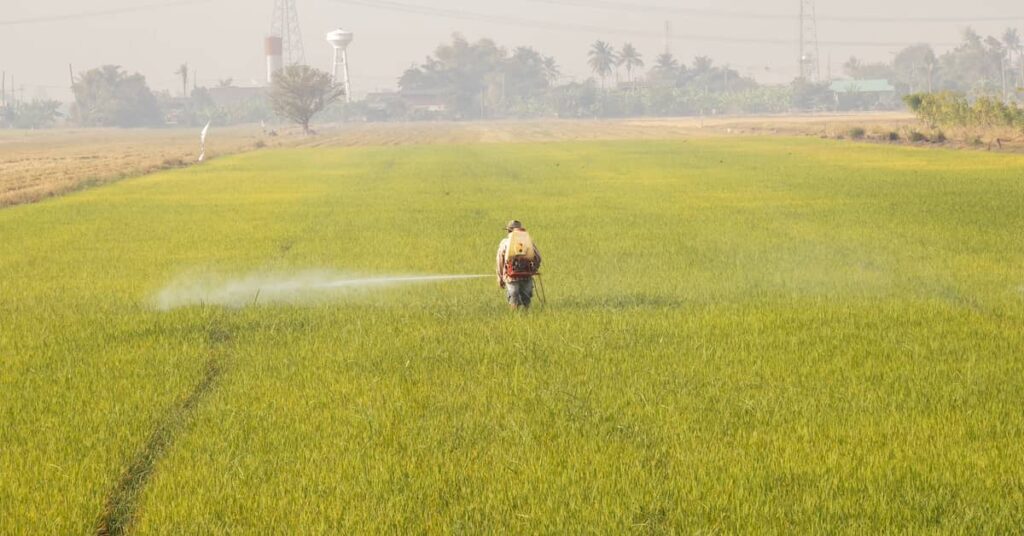 Farmer spraying paraquat on fields | Burg Simpson Law Firm