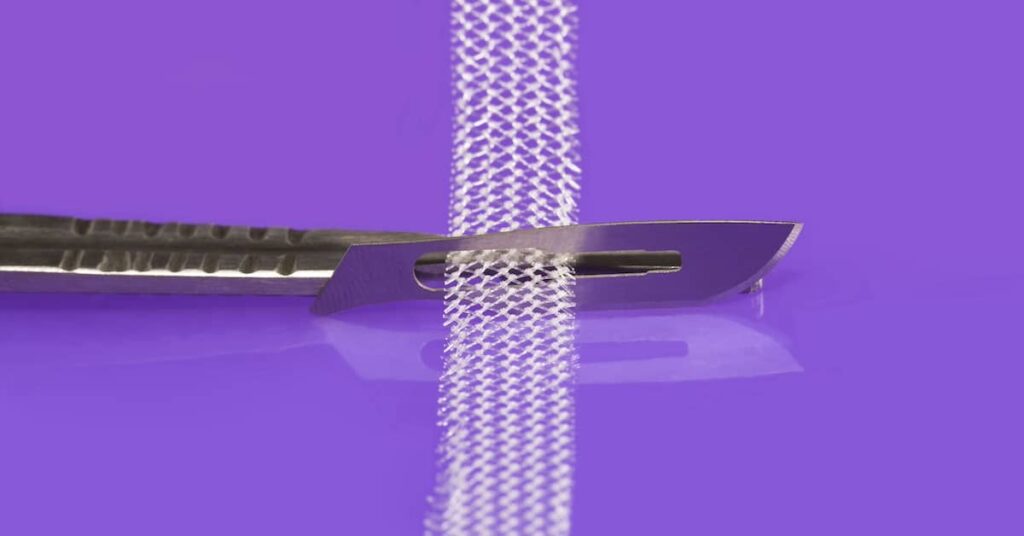 Strip of transvaginal mesh and surgical knife | Burg Simpson Law Firm