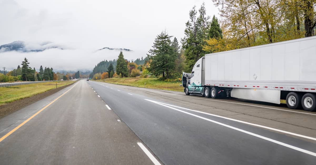Semi-truck broken down on the side of a highway after an accident | Burg Simpson