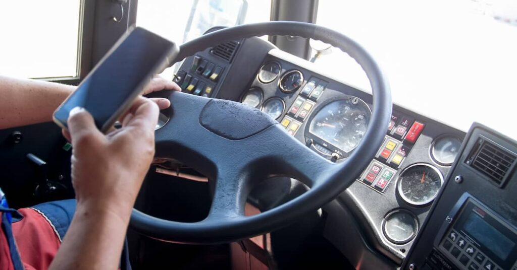 Distracted truck driver using his cell phone behind the wheel | Burg Simpson