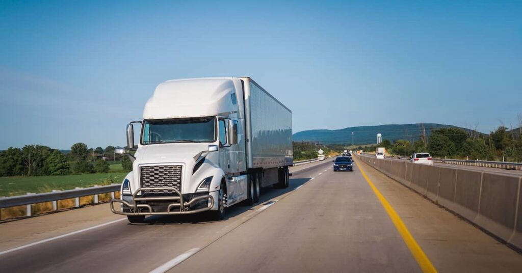 18-wheeler commercial semi-truck on a divided highway | Burg Simpson