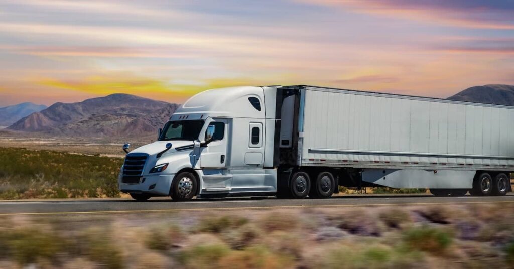 Semi-truck traveling fast on a road in Arizona | Burg Simpson
