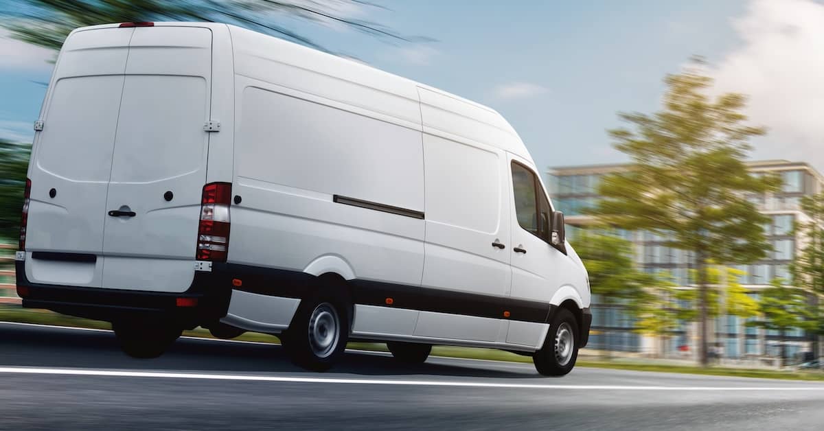 Delivery van driving too fast down a city street | Burg Simpson