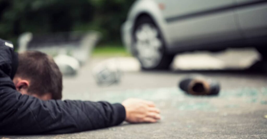 Man lying dead on the ground after a fatal pedestrian accident with a car | Burg Simpson