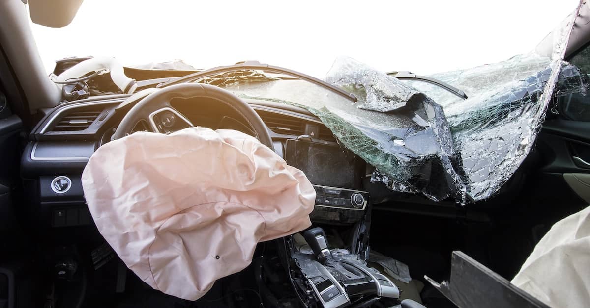 Inside the front section of a badly damaged vehicle after a car accident | Burg Simpson