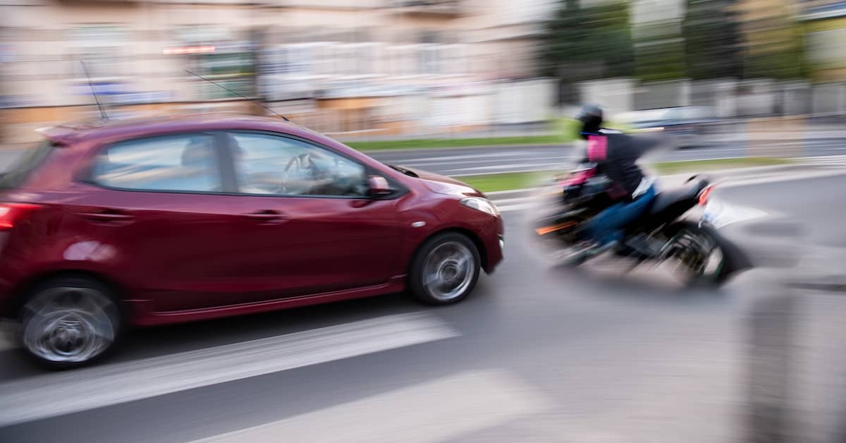 Motorcyclist making a left turn about to be struck by a careless driver | Burg Simpson