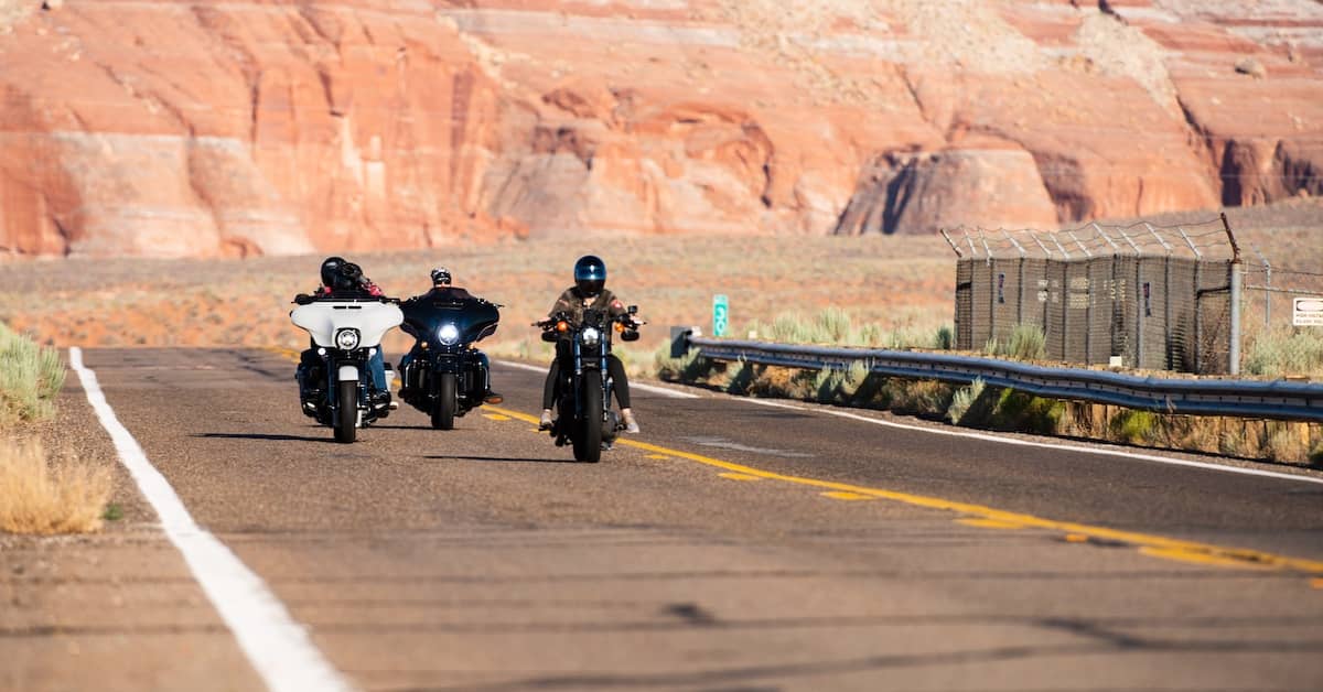 Motorcyclists riding through a desert canyon in Arizona | Burg Simpson