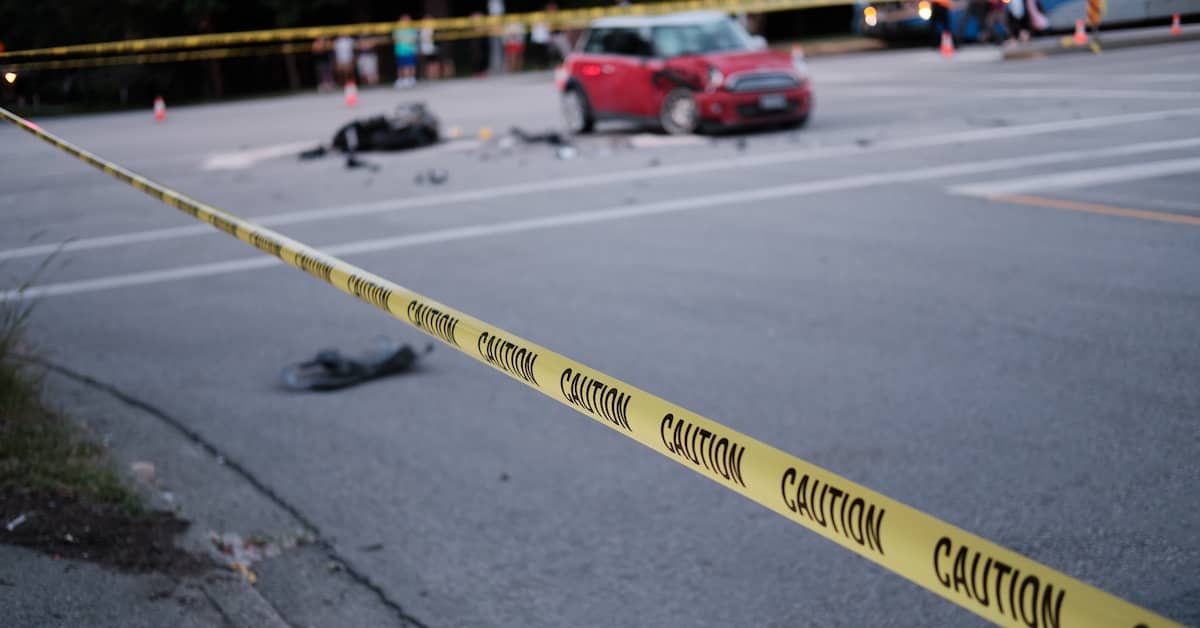 Accident scene sealed off with caution tape after a car turned left in front of a motorcycle in an intersection | Burg Simpson