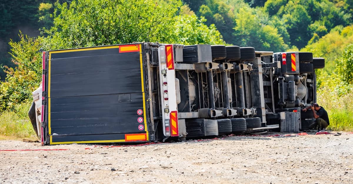 Semi-truck lying on its side after an accident | Burg Simpson